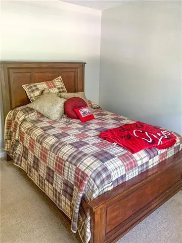 a bedroom with a bed and a lamp