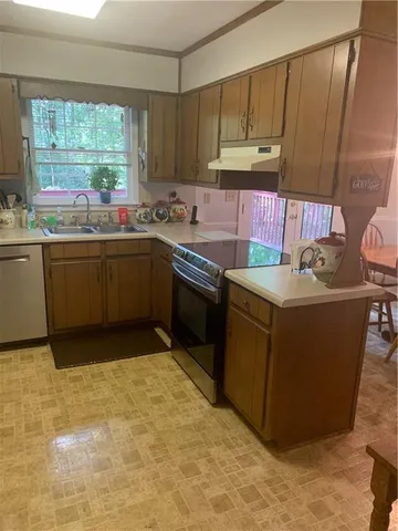 a kitchen with a sink cabinets and window
