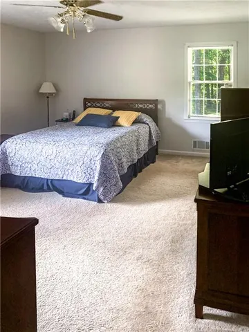 a bedroom with a bed and a television