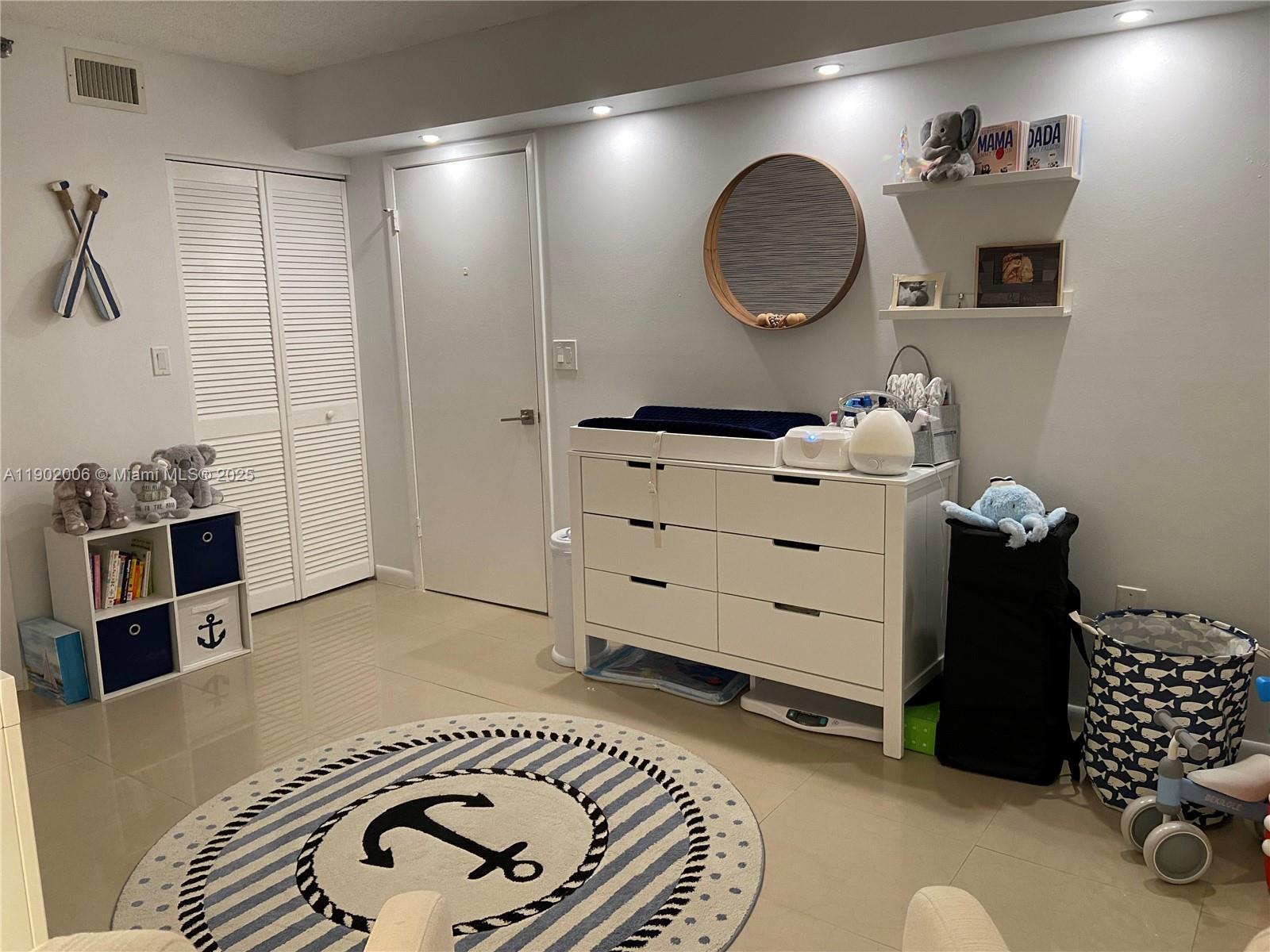 540 Brickell Key Drive, Unit 711 Miami, FL 33131 - Photo 24 of 37 a room with furniture and a wooden floor