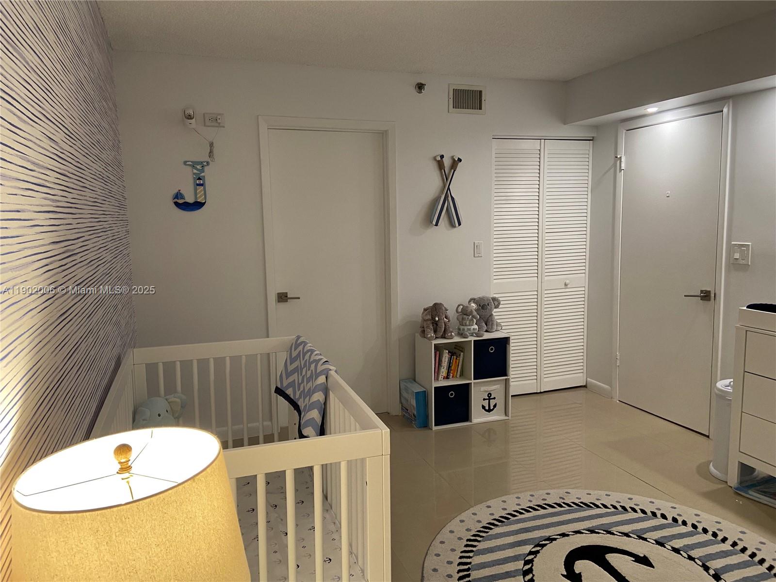 540 Brickell Key Drive, Unit 711 Miami, FL 33131 - Photo 25 of 37 a bedroom with a bed and a couch