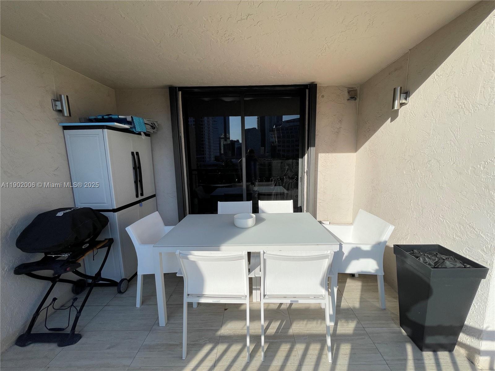 540 Brickell Key Drive, Unit 711 Miami, FL 33131 - Photo 35 of 37 a view of a dining room with furniture and wooden floor