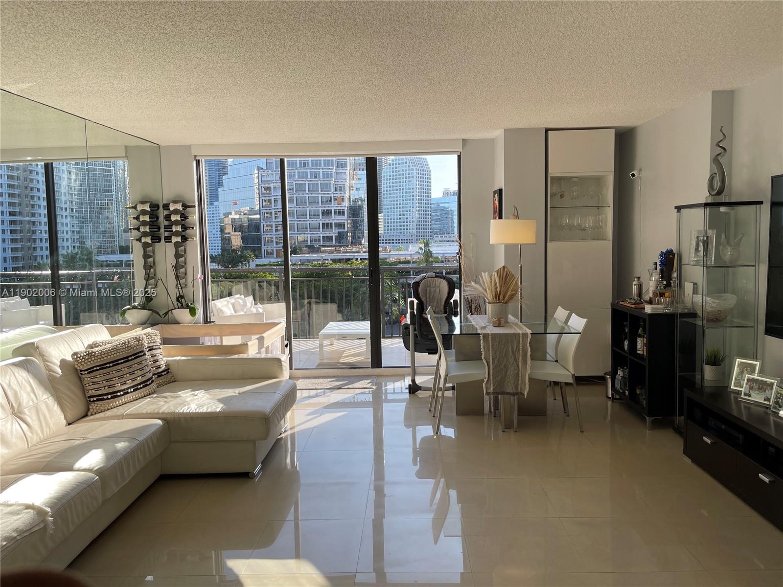 540 Brickell Key Drive, Unit 711 Miami, FL 33131 - Photo 6 of 37 a living room with furniture and a floor to ceiling window