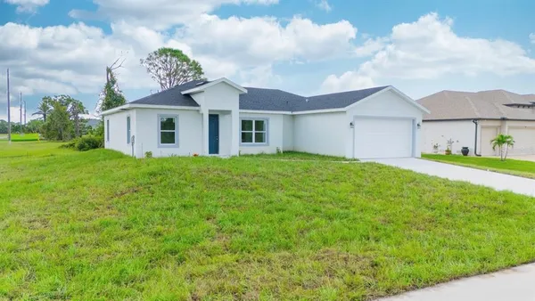 a view of a house with a yard and garage