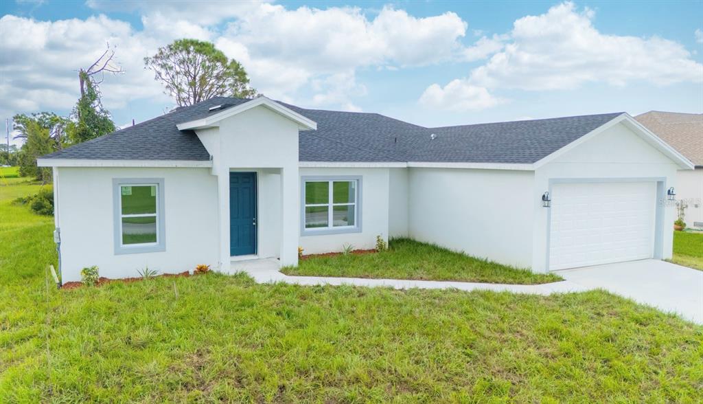 46 Master Drive Placida, FL 33946 - Photo 12 of 44 a view of a house with a yard and garage