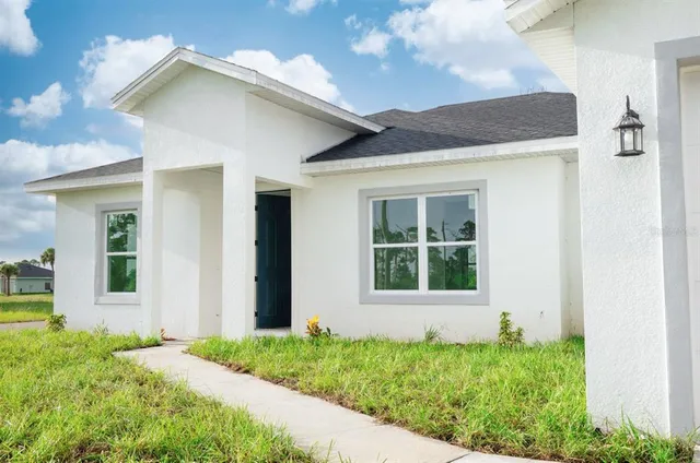 a view of a dining room with furniture and a chandelier