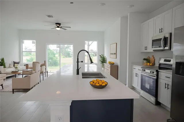 a kitchen with a sink a stove and refrigerator
