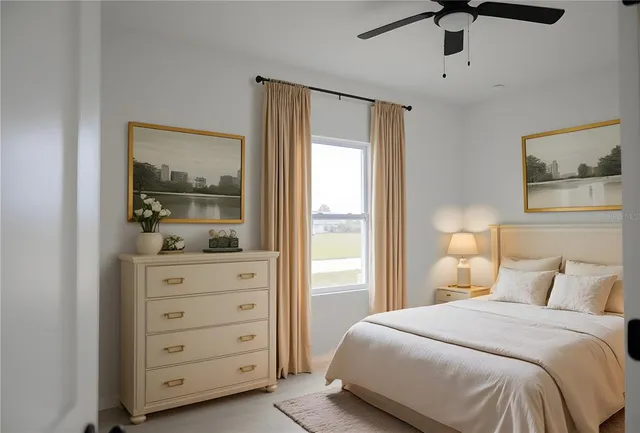 a bedroom with bed and a potted plant