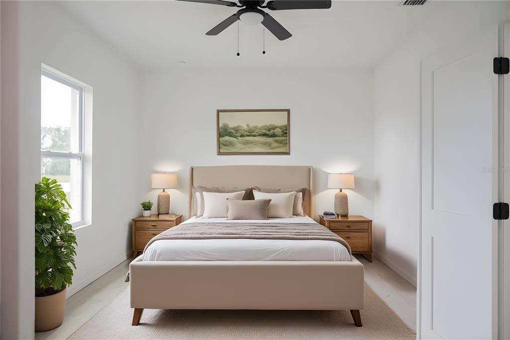 46 Master Drive Placida, FL 33946 - Photo 23 of 44 a bedroom with bed and a potted plant