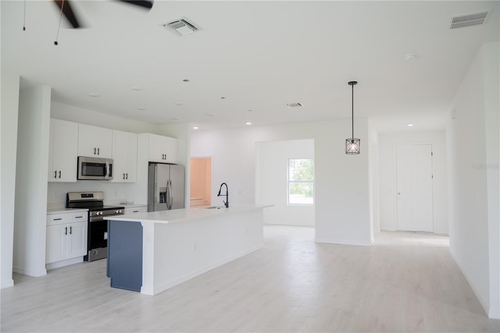 46 Master Drive Placida, FL 33946 - Photo 33 of 44 a kitchen with kitchen island a sink stove and refrigerator