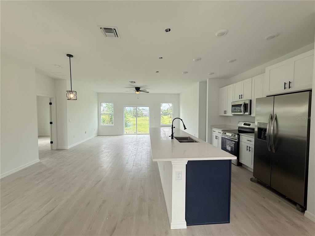 46 Master Drive Placida, FL 33946 - Photo 36 of 44 a view of a kitchen with a sink refrigerator and wooden floor