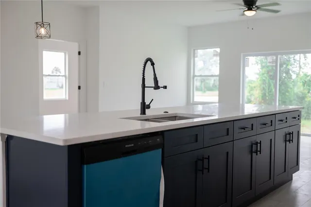 a kitchen with stainless steel appliances a stove refrigerator sink and microwave