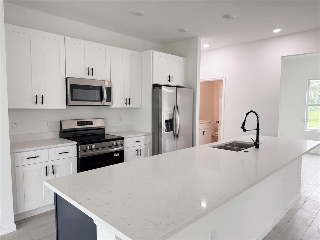 46 Master Drive Placida, FL 33946 - Photo 41 of 44 a kitchen with stainless steel appliances a stove refrigerator sink and microwave