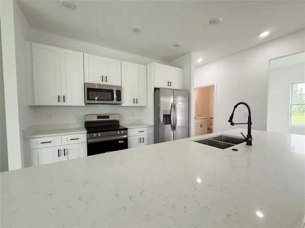 an empty room with windows and closet