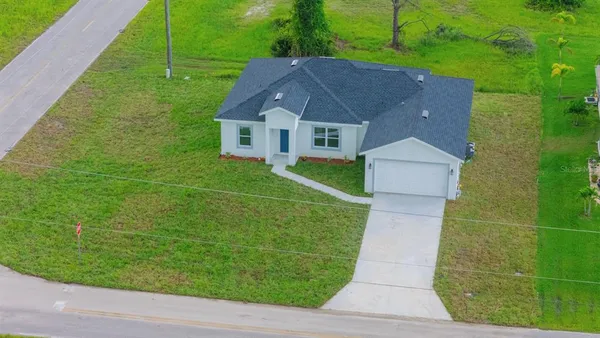 an aerial view of a house with outdoor space and street view