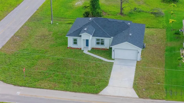 an aerial view of a house with outdoor space and street view