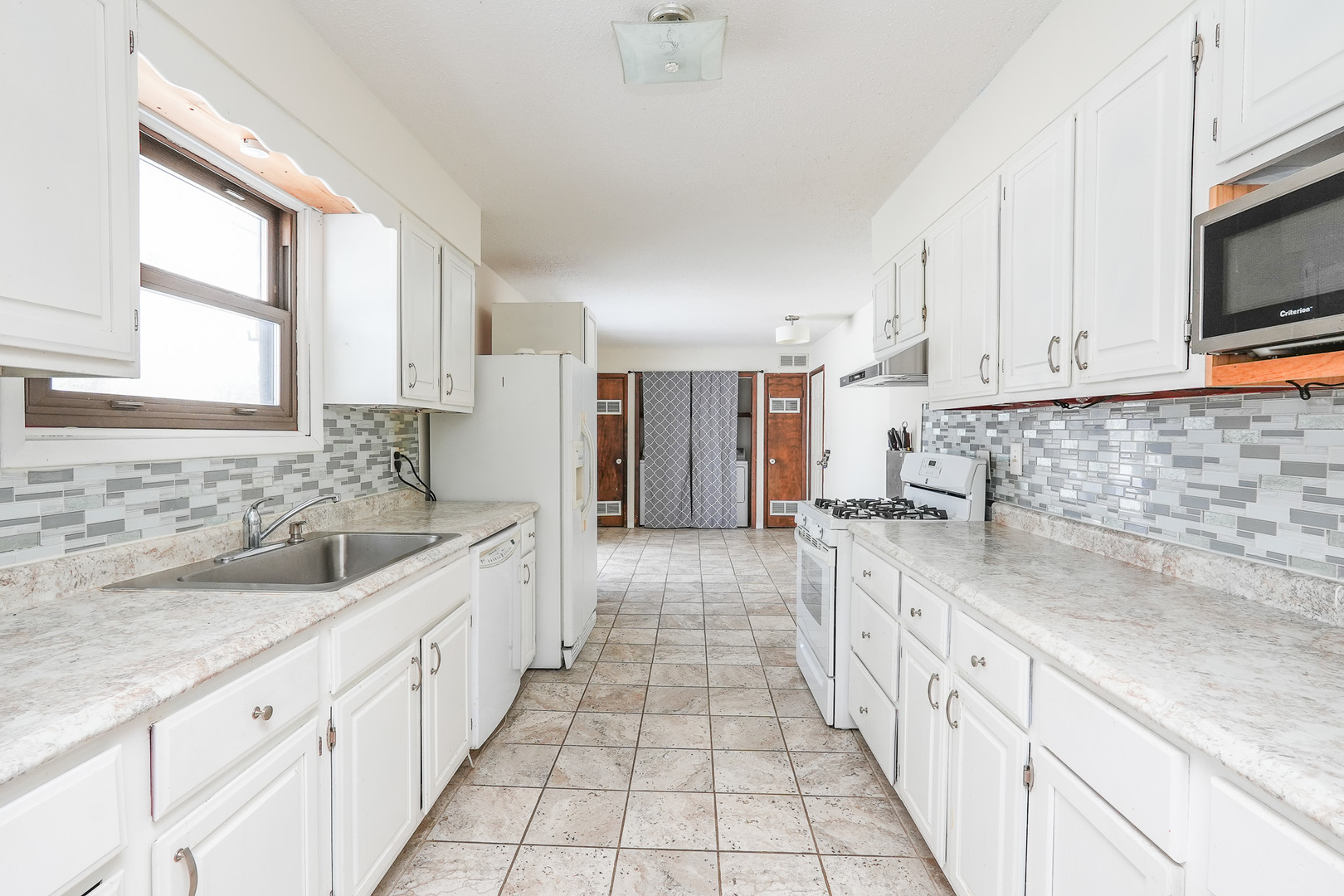 165 East Baker Street Manteno, IL 60950 - Photo 13 of 38 a large kitchen with stainless steel appliances granite countertop a sink and a stove