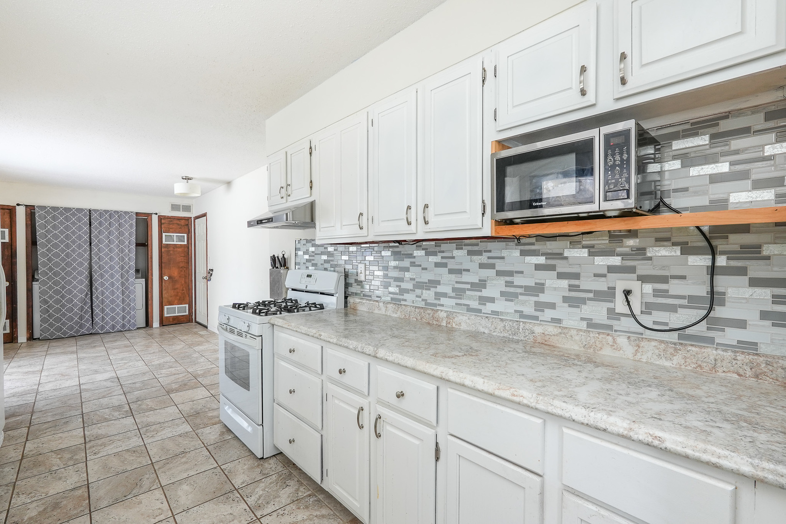 165 East Baker Street Manteno, IL 60950 - Photo 15 of 38 a kitchen with stainless steel appliances granite countertop a sink a stove and cabinets