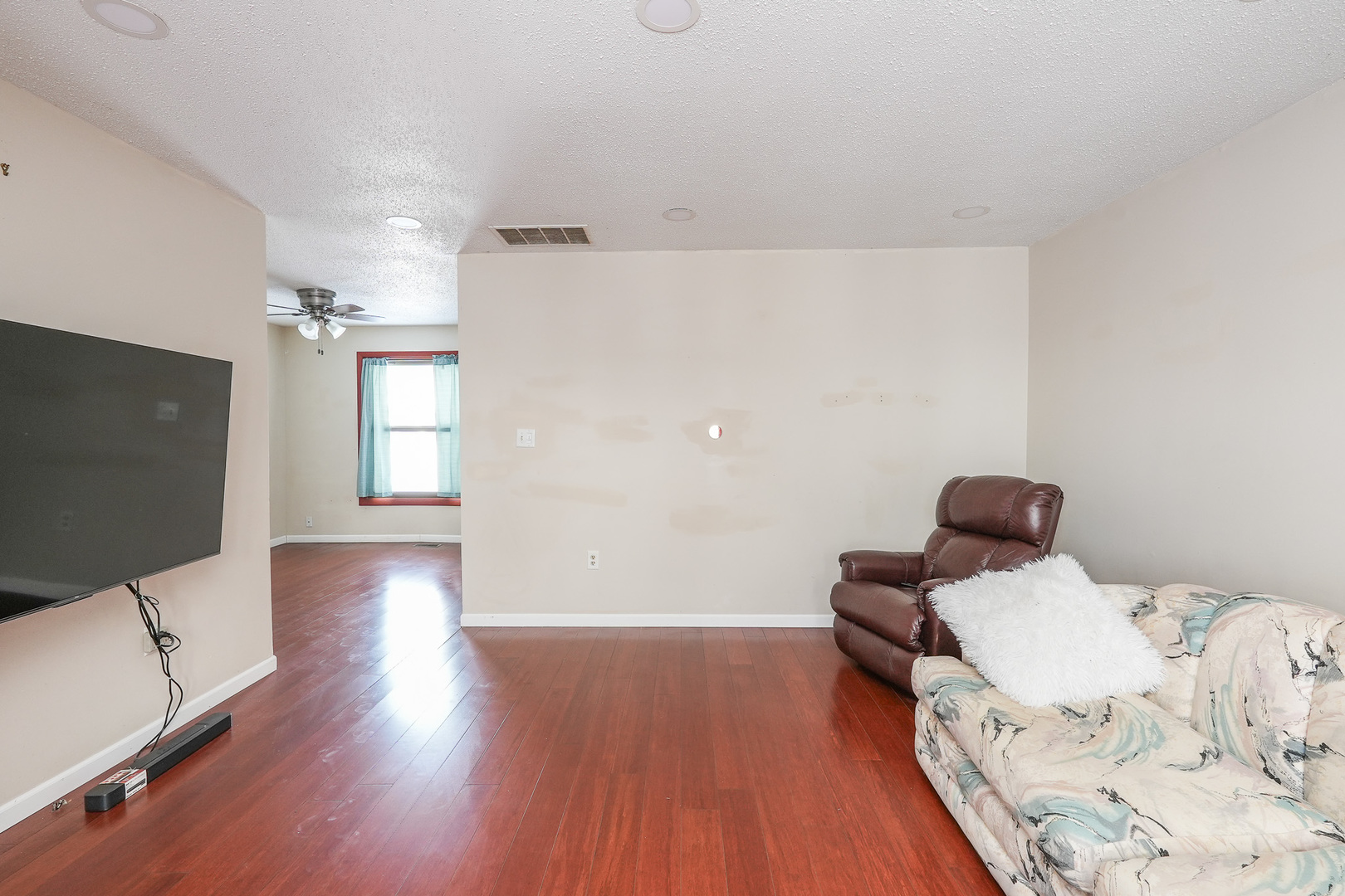 165 East Baker Street Manteno, IL 60950 - Photo 4 of 38 a bedroom with a bed and wooden floor