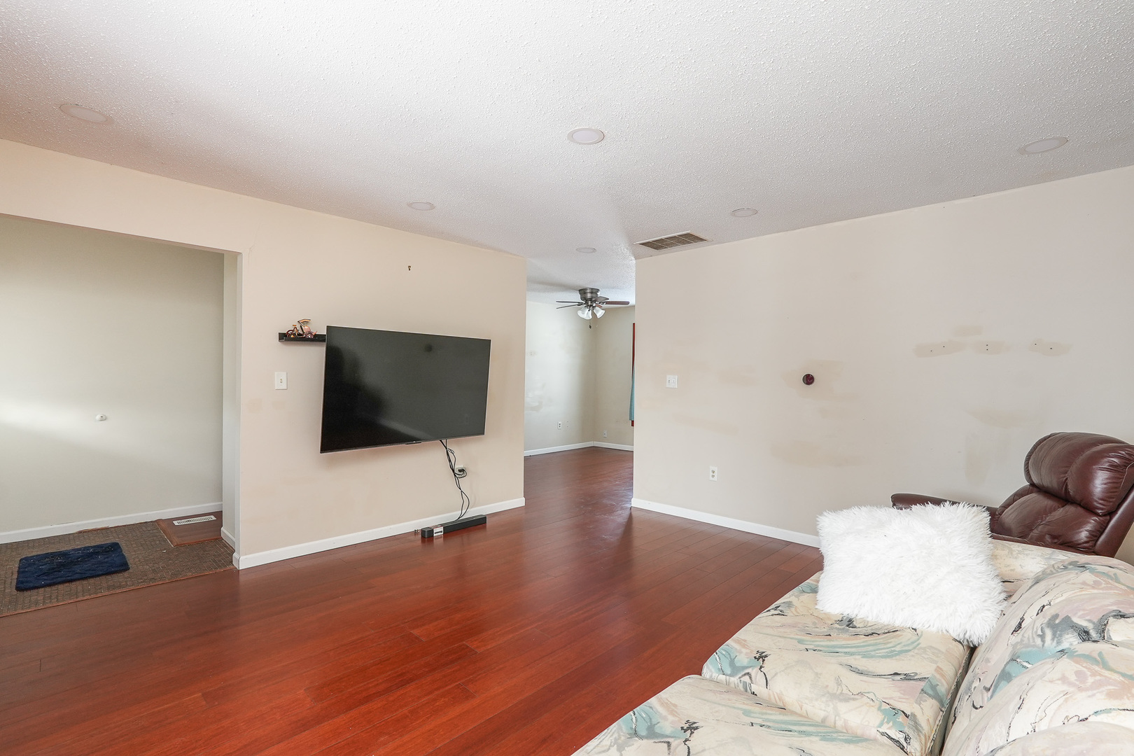 165 East Baker Street Manteno, IL 60950 - Photo 5 of 38 a bedroom with a bed and a flat screen tv