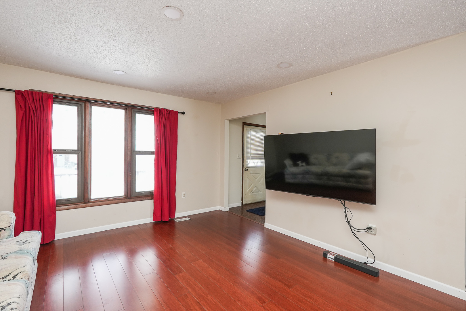 165 East Baker Street Manteno, IL 60950 - Photo 6 of 38 a living room with hardwood floor and a flat screen tv