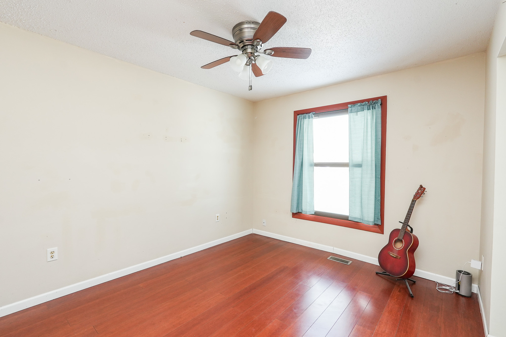 165 East Baker Street Manteno, IL 60950 - Photo 8 of 38 an empty room with wooden floor fan and windows