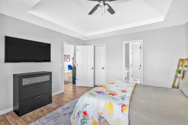 a bedroom with a bed and a flat screen tv