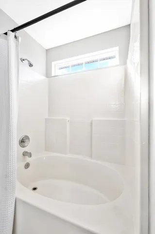 a bathroom with a shower and a bath tub