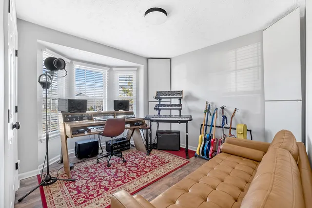 a living room with furniture a rug and a window