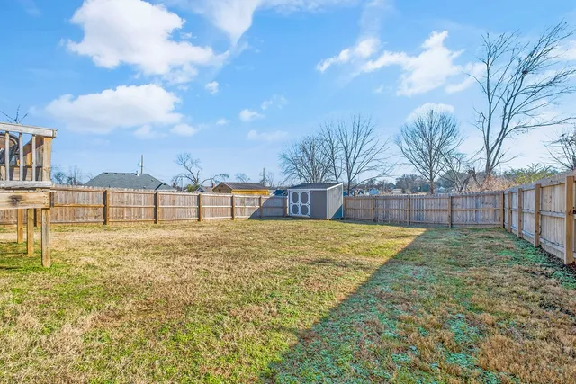 a view of pool with a yard