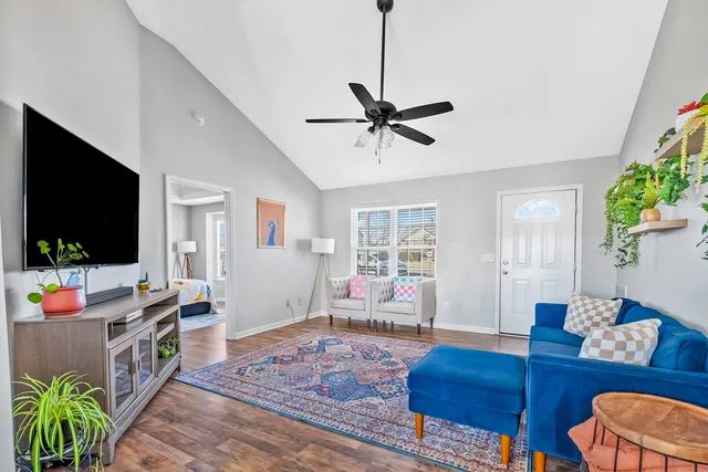 a living room with furniture and a flat screen tv