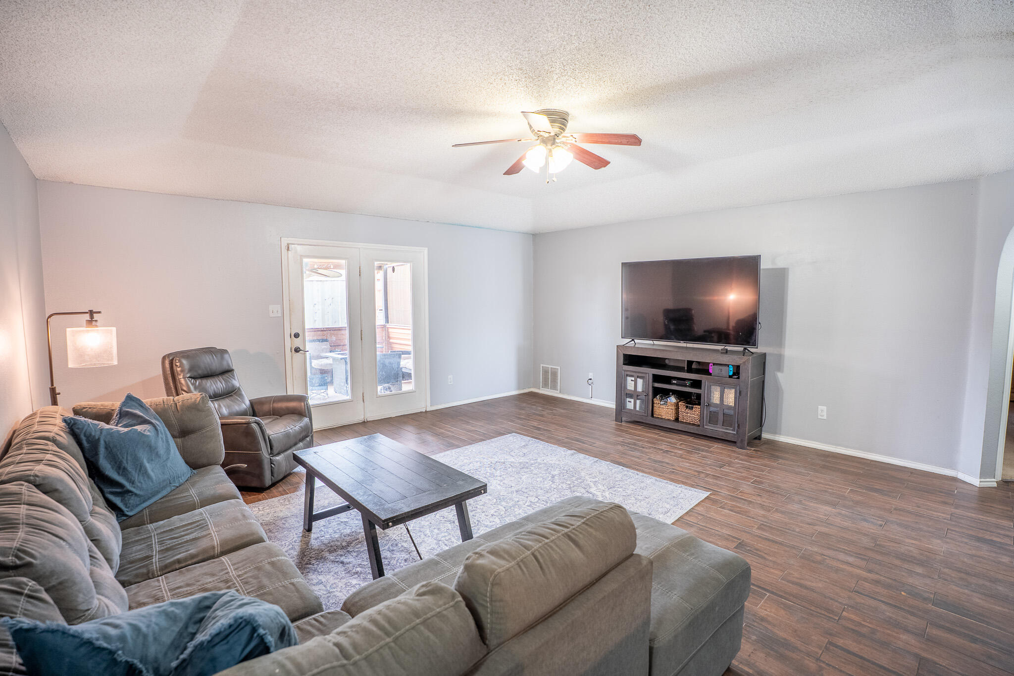 1609 78th Street Lubbock, TX 79423 - Photo 4 of 36 a living room with furniture and a flat screen tv