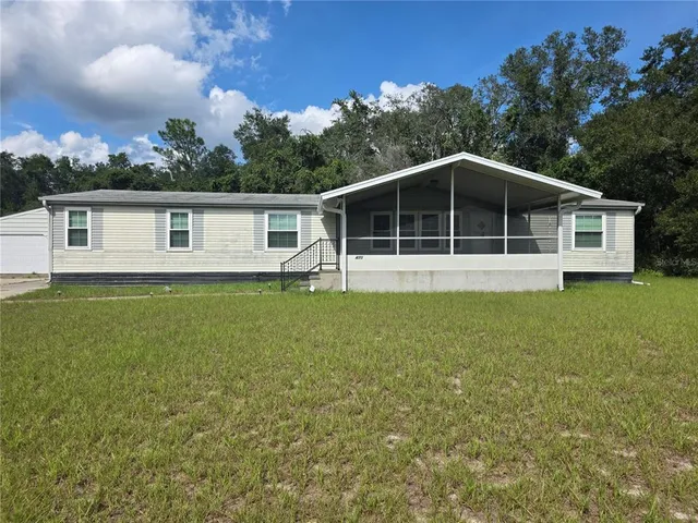 a big house with a big yard and large trees