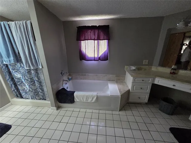 a bathroom with a bathtub sink and mirror