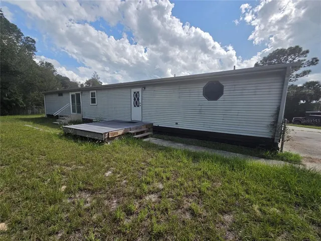 a backyard of a house with lots of green space