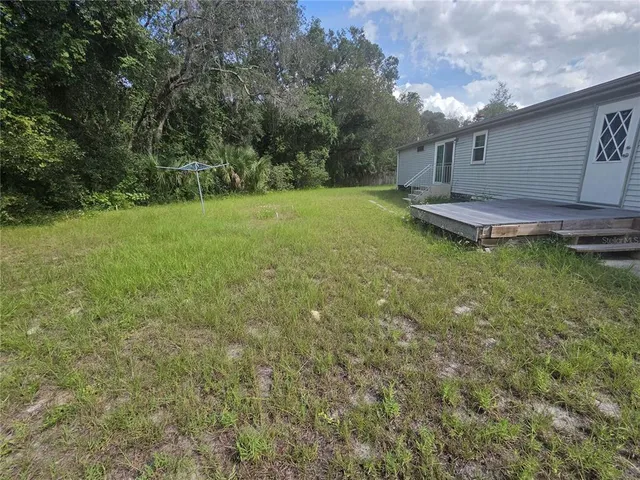 a backyard of a house with lots of green space