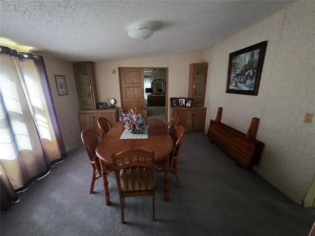a view of a dining room with furniture and window
