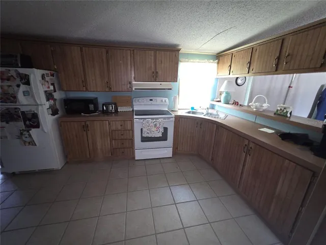 a kitchen with a cabinets and steel stainless steel appliances