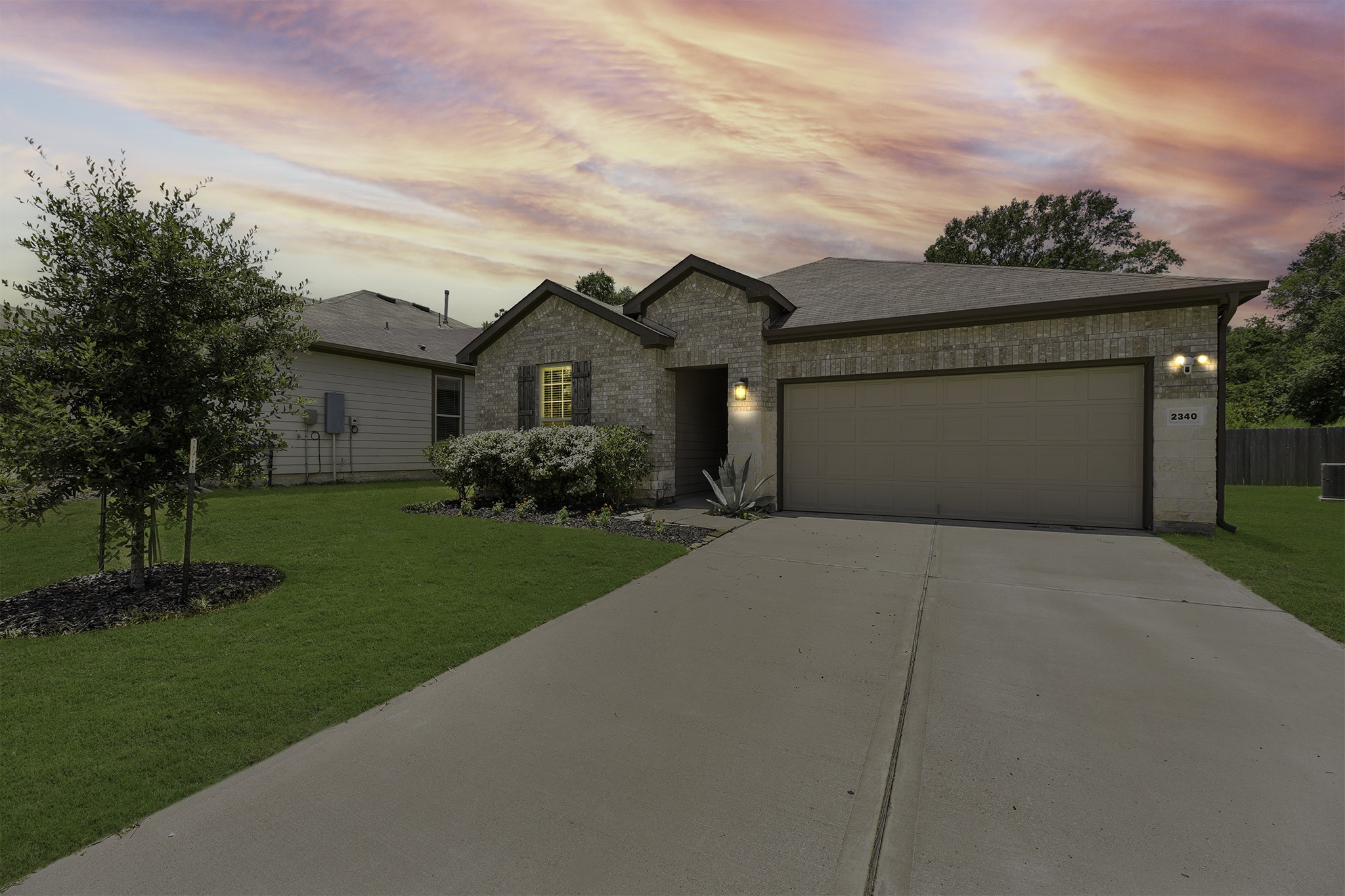 a front view of a house with a garden
