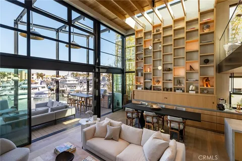 a view of a dining room with furniture and floor to ceiling window