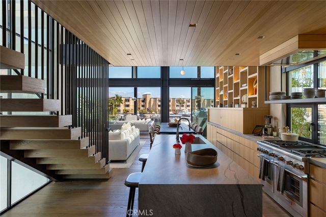 a living room with granite countertop kitchen stove and a window