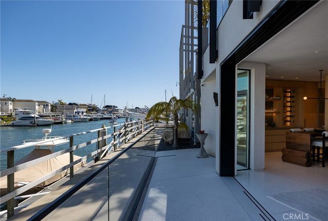 a view of a balcony with chairs and a potted plant