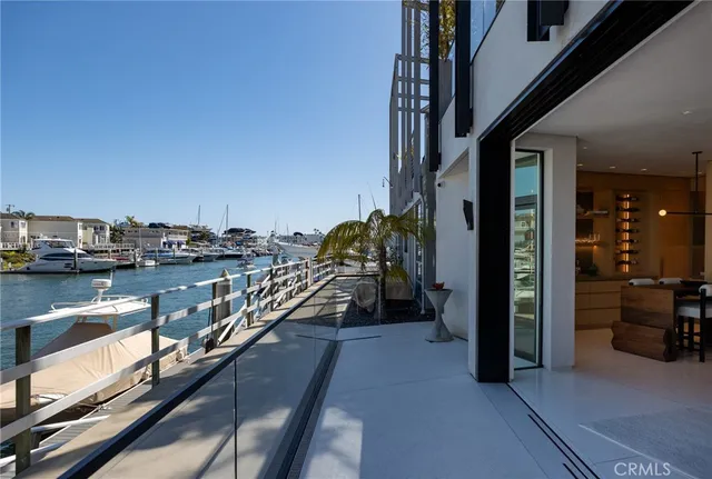 a view of a balcony with chairs and a potted plant