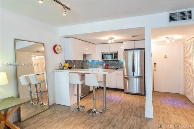 a kitchen with a sink cabinets and wooden floor