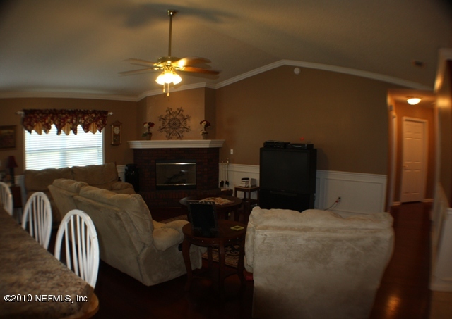 54178 Snyder Road Callahan, FL 32011 - Photo 12 of 14 a room with furniture a chandelier and a window