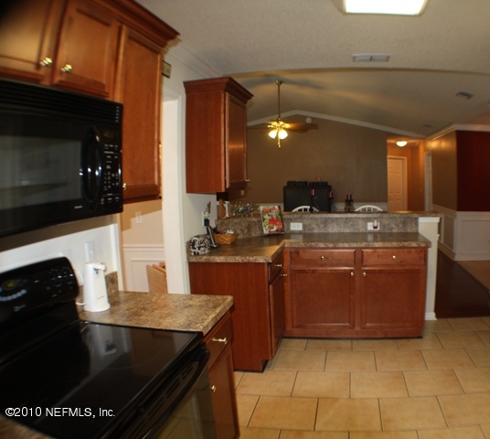 54178 Snyder Road Callahan, FL 32011 - Photo 13 of 14 a kitchen with a sink and cabinets