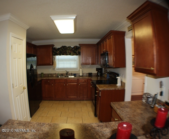 54178 Snyder Road Callahan, FL 32011 - Photo 4 of 14 a kitchen with granite countertop a refrigerator stove and sink