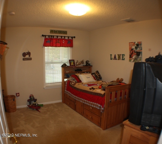 54178 Snyder Road Callahan, FL 32011 - Photo 9 of 14 a bed sitting in a room next to a window