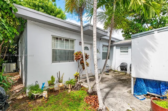 a potted plant sitting in front of a house