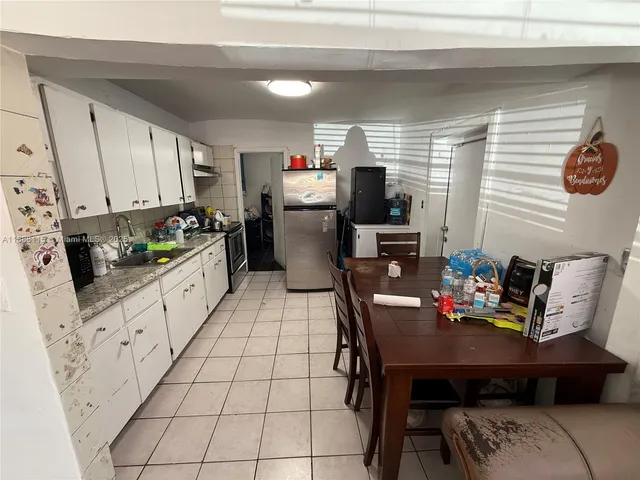 a kitchen with granite countertop a sink a stove and a microwave